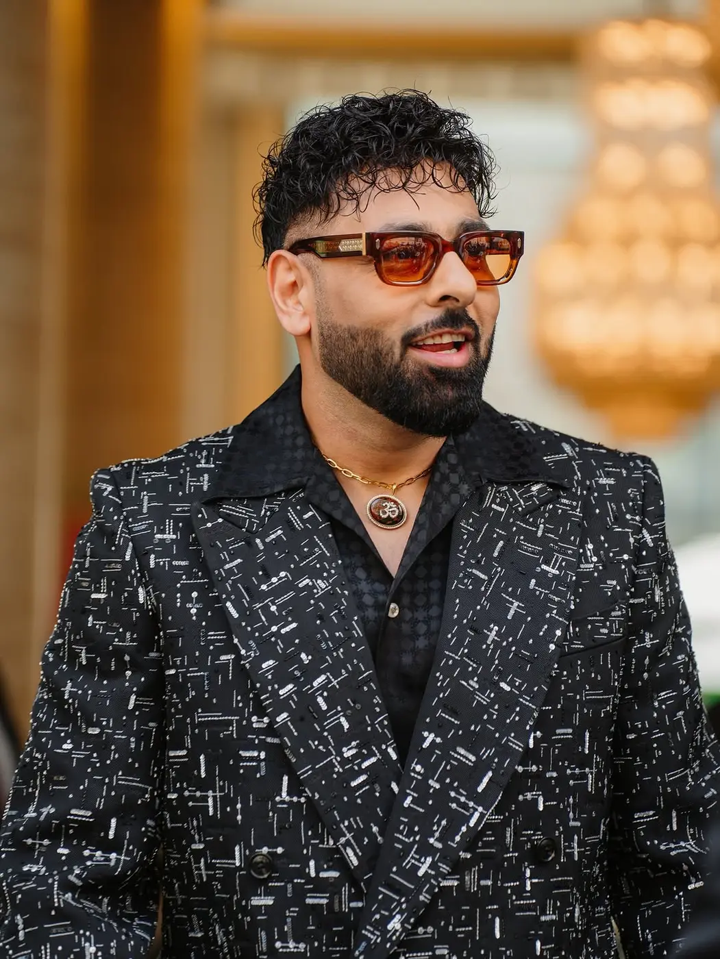 Portrait of a star in sunglasses and a patterned blazer